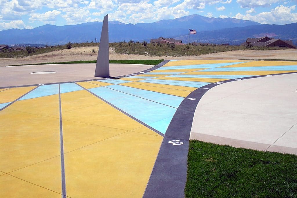 Large school play space with sun dial Microtop - ST Concrete Overlay - Colorado Hardscapes