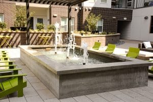 Board form water feature in apartment courtyard