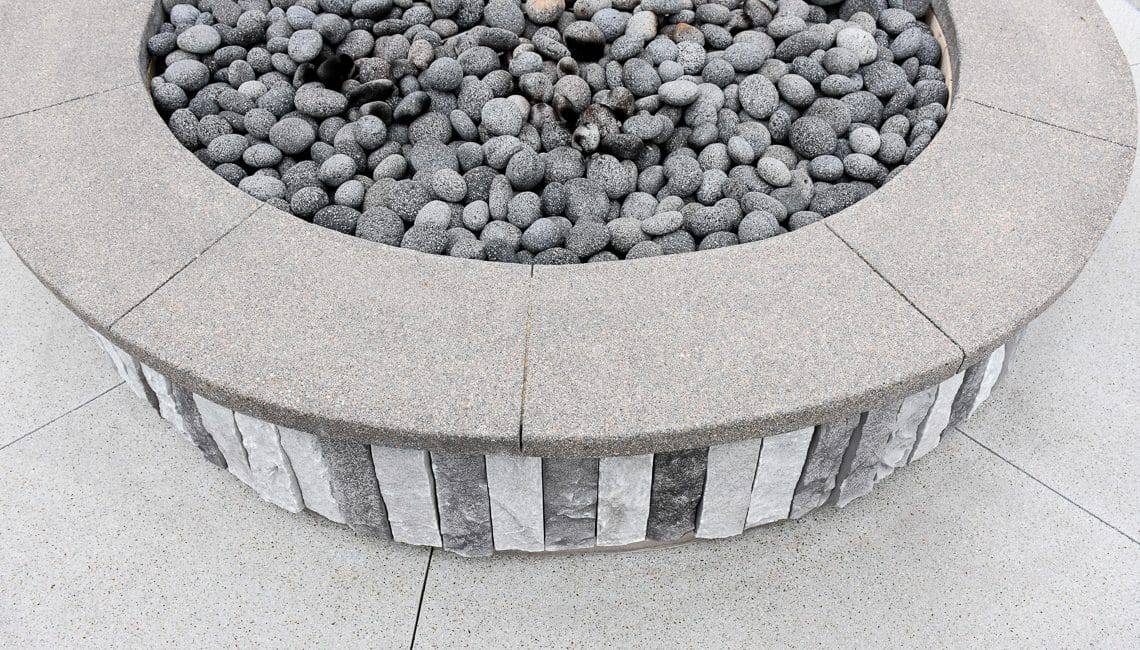 Up close perspective of Sandscape Refined fire pit at apartment complex.