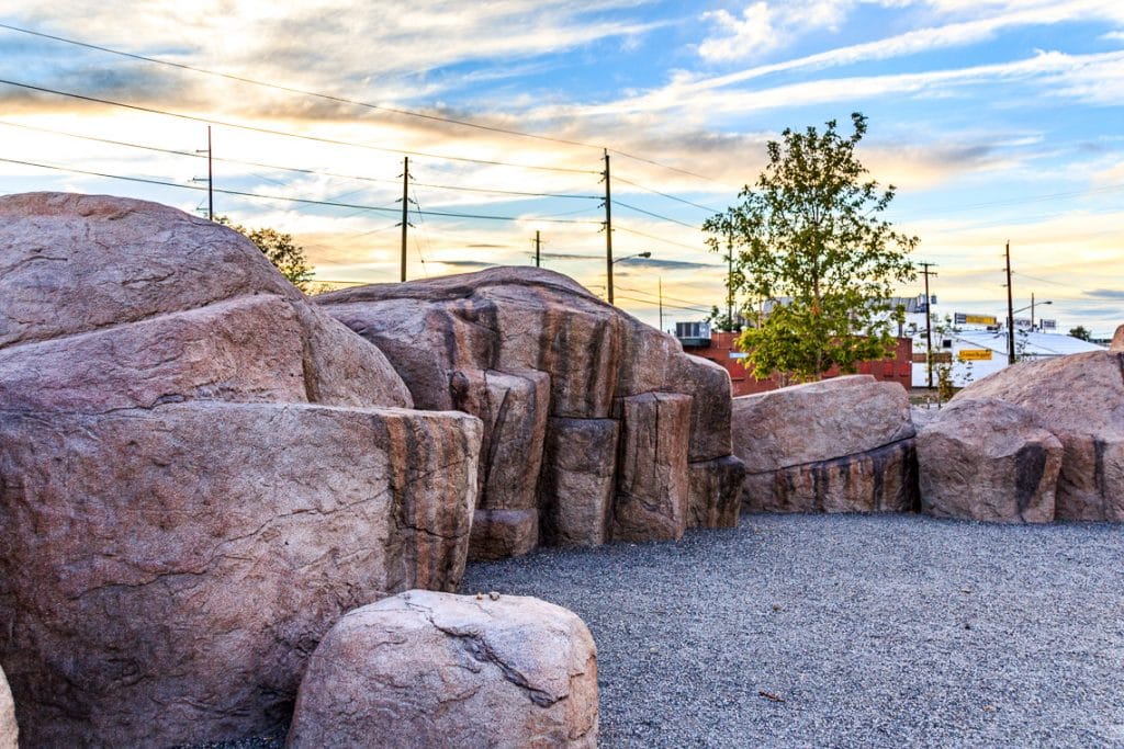 large concrete boulders create a play space in the park