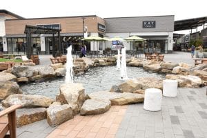 Water feature at outlets surrounded by natural boulders.