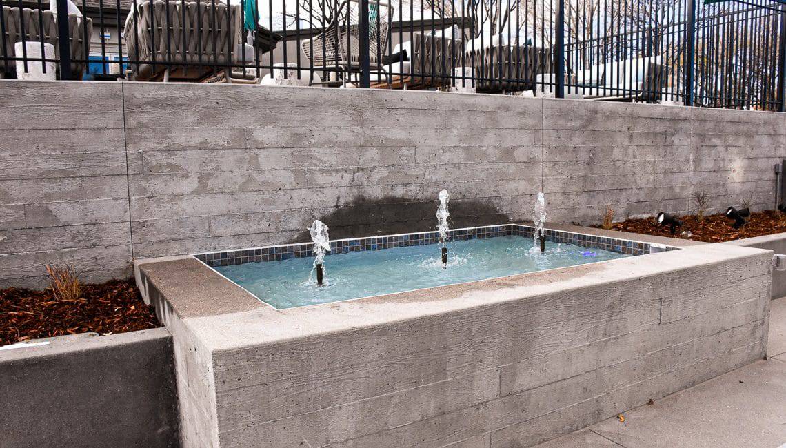 Board form walls were used on the front and sides of this water feature basin.