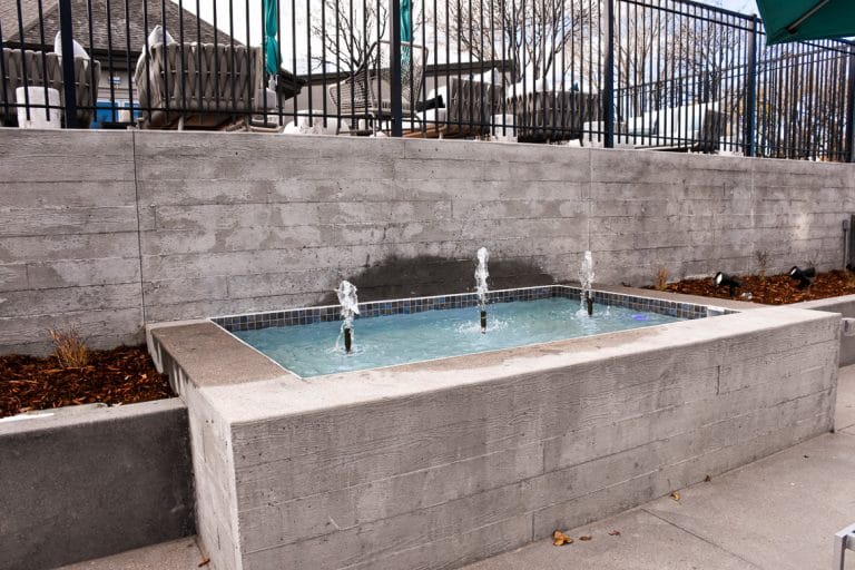 Board form walls were used on the front and sides of this water feature basin.