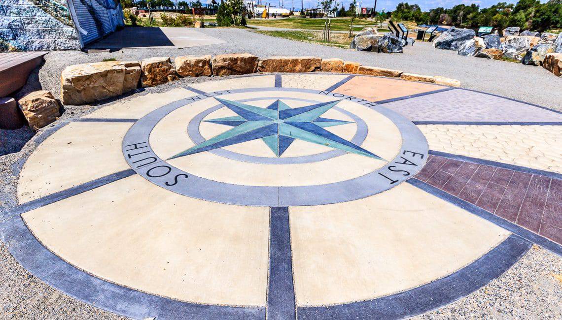 Compass rose created out of different concrete textures, colors and style create public art in the parks
