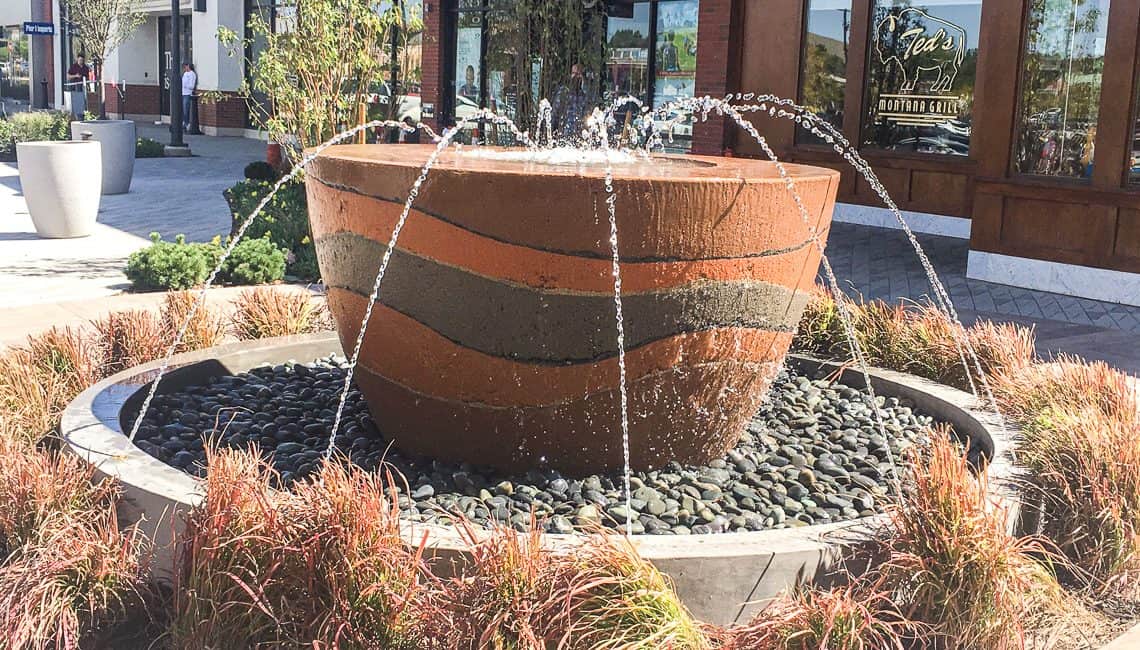 Concrete cup shaped water features with nozzles spraying water into its center