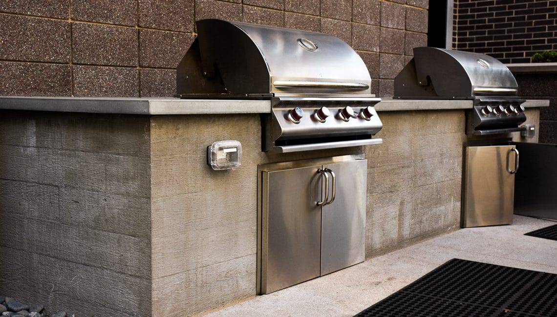 Apartment courtyard BBQ grill area with a board form walls