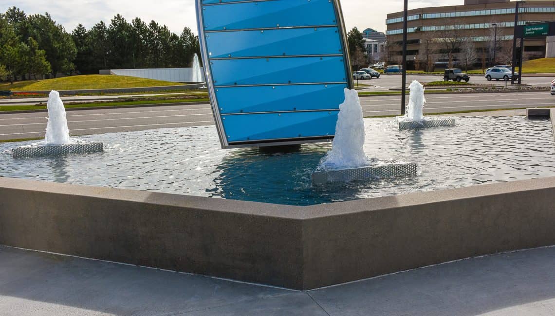 Denver Tech Center water feature with three geyser nozzles and a large prism centerpiece.