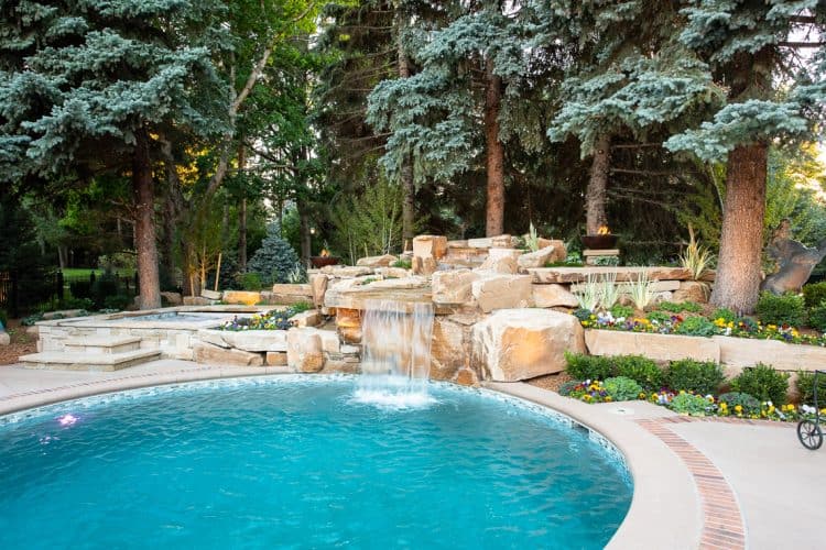 Dream backyard at private residence with 8x8 spa and sandstone waterfall.