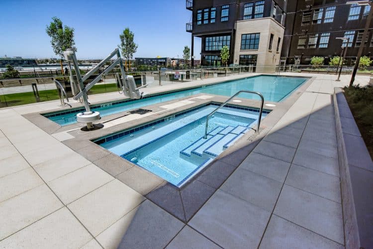 DriveTrain Pool and Spa with Sandscape coping, hand rail, and drainage.